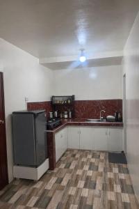 an empty kitchen with a sink and a refrigerator at Tribo Zamani in General Luna