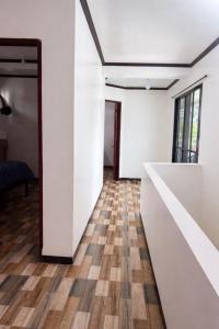 a room with white walls and a wooden floor at Tribo Zamani in General Luna +2 photos
