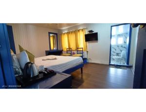 a hotel room with a bed and a bathroom at Hotel Alpine Ridge, Gulmarg in Gulmarg