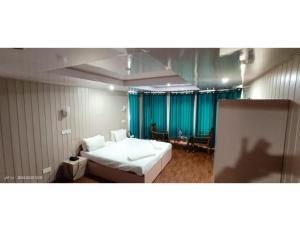 a room with a bed and a person taking a picture at Hotel Alpine Ridge, Gulmarg in Gulmarg
