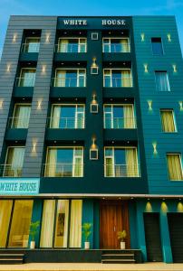 a blue building with the words white house and my little house at The W H I T E Amritsar in Amritsar