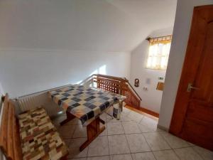 a room with a table and a staircase with a window at Mohos Vendégfogadó in Kelemér