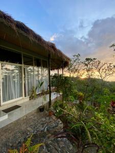 a house with a view of the ocean and the sunset at Oceanview Cottage Cempaga - entire 2 BR Bungalow 135 sqm in Temukus
