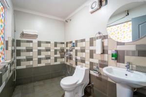 a bathroom with a toilet and a sink at Beach Walk Resort Walk In Morjim Beach Goa in Morjim