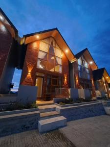 a house with lights on the side of it at Carika Cabin in Diyeng