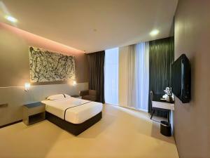 a hotel room with a bed and a television at Seeds Hotel Premier One City Subang Previously eCity Hotel One City in Subang Jaya
