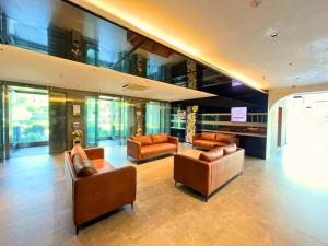a lobby with couches and chairs in a building at Seeds Hotel Premier One City Subang Previously eCity Hotel One City in Subang Jaya +29 photos