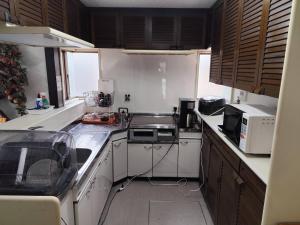 a kitchen with a stove and a microwave at 夢尽くし in Aira +32 photos