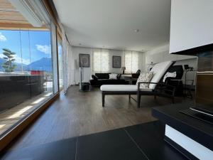 a living room with a couch and a chair and a table at Villa in Tyrol with pool in Stanz bei Landeck
