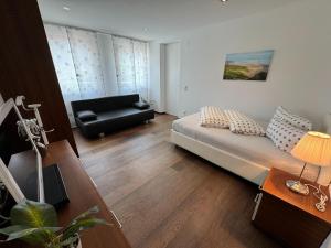 a living room with a bed and a couch at Villa in Tyrol with pool in Stanz bei Landeck +30 photos