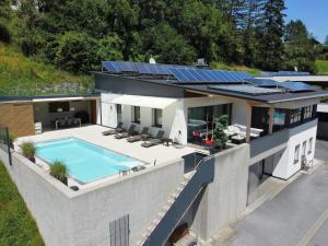 an aerial view of a house with a swimming pool at Villa in Tyrol with pool in Stanz bei Landeck