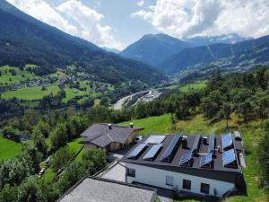 an aerial view of a house with solar panels on the roof at Villa in Tyrol with pool in Stanz bei Landeck