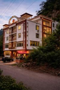 a hotel building with a car parked in front of it at Bridge Residency in Muzaffarabad