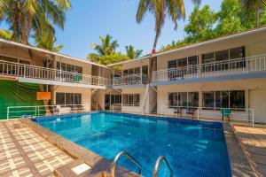 a large swimming pool in front of a building at Beach Walk Resort Walk In Morjim Beach Goa in Morjim