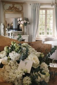 a living room with a bunch of white flowers on a couch at Hotel Villa Catarie in Guéthary +28 photos
