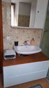 a bathroom with a sink and a mirror at La Dimora di Beatrice in Santa Brigida +106 photos