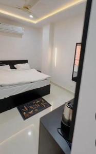 a small white room with a bed in it at Zoz jhodpur in Jodhpur