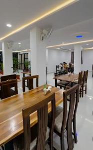 a dining room with wooden tables and chairs at Zoz jhodpur in Jodhpur