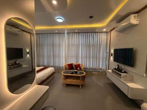 a room with a mirror and a couch and a chair at The Hotel Art 8 in Pātan