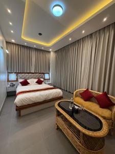 a bedroom with a bed and a couch and a table at The Hotel Art 8 in Pātan