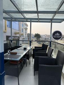 a restaurant with a table and chairs and a view of a river at The Hotel Art 8 in Pātan