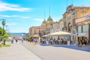 a group of people walking down a city street at Three Tails House in Capezzano Pianore,