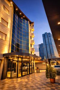 a building with two tall buildings in a city at Panorama Amman Hotel in Amman