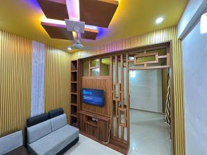 a living room with a couch and a tv at Richard's Homestay 7 BHK in Thiruvalla