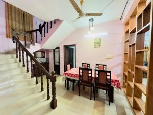 a room with a staircase and a room with a bed at Richard's Homestay 7 BHK in Thiruvalla