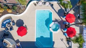 an overhead view of a swimming pool with umbrellas at Panorama Peak Luxury Retreat in Poway
