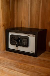 a microwave oven sitting on top of a wooden cabinet at Cahya Restu Ubud Villa in Ubud