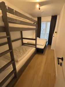 a room with two bunk beds and a ladder at Orion NorthSea Suite in Blankenberge