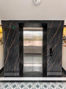 a elevator in a building with black and gold marble at Calla Lily Hotel in Sapa