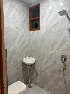 a bathroom with a sink and a toilet at Aanya Bnb in Zirakpur