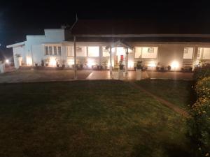 a house at night with the lights on at Milestone Heritage Inn in Jāmb