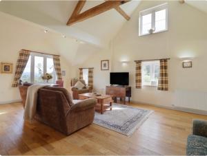 a living room with a couch and a table at Pandy Barn Berriew in Welshpool