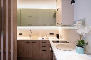 a kitchen with white cabinets and a sink at The Alley in Litochoro