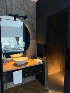 a bathroom with a sink and a mirror at Cavria in Şurdeşti +32 photos