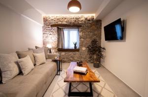 a living room with a couch and a table at The Alley in Litochoro
