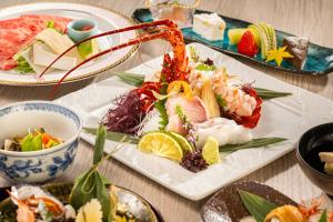 a plate of food on a table with sushi at Ryotei Tanokura in Yufu