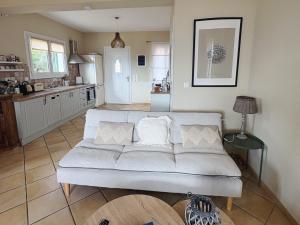a living room with a couch and a kitchen at Sea View Villa Irene - Private Pool and Sunset Terrace in Evretí