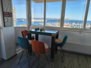a table and chairs in a room with windows at Apartments Kike&Ana in Split