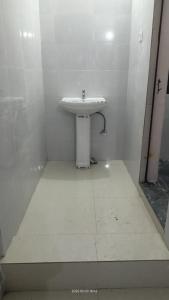a bathroom with a white sink in a room at Hotel Mahadev in Sonprayag