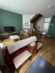 a living room with a couch and a table at Le gîte de Marie in Gramat