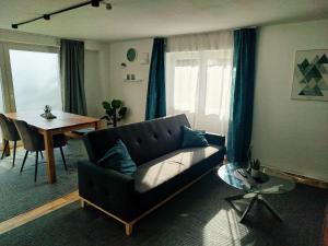 a living room with a couch and a table at Ferienwohnung Oberhof in Murg