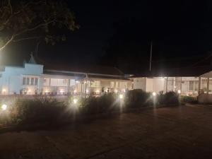 a house with lights in front of it at night at Milestone Heritage Inn in Jāmb