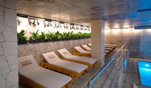 a waiting room with white chairs and plants at LOFT Hotel & SPA in Bukovel