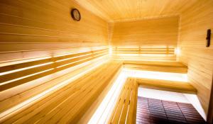 a wooden sauna with a clock in the middle at LOFT Hotel & SPA in Bukovel