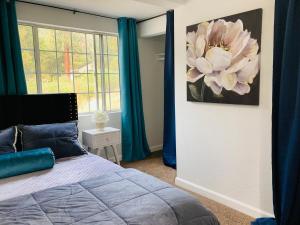 a bedroom with a bed and a large flower on the wall at Dafna, Unit 4 in Cromberg