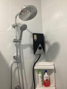 a shower with a shower head in a bathroom at Naris Riverside in Ban Wat Tha Maprang +9 photos